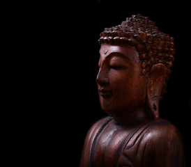 Buddha portrait against dark background