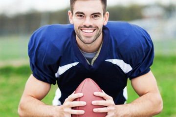 American football player holding ball © pikselstock