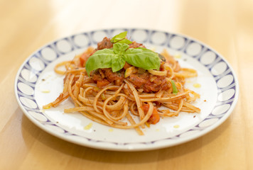 Plate with noodles and tomato sauce