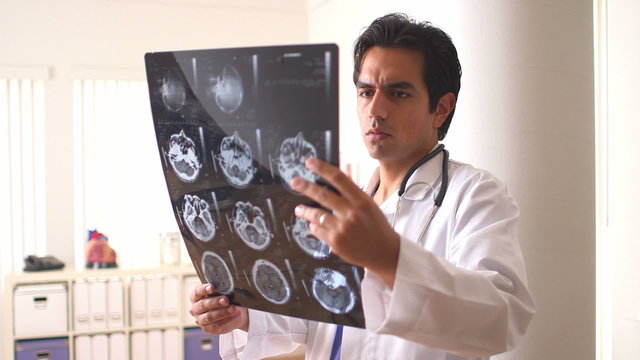 Hispanic doctor reviewing scans