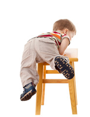Little boy climbing on stool