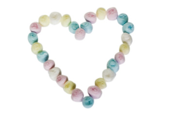 Close-up of a heart shape made from colorful cotton balls