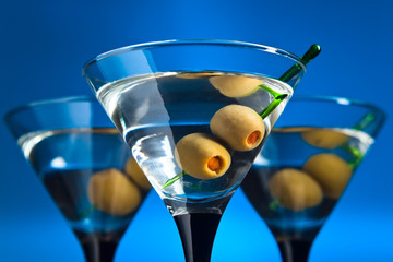 glasses with martini and green olives