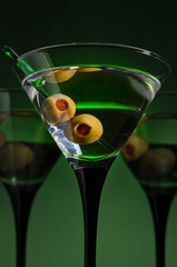 glasses with martini and green olives
