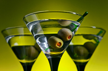 glasses with martini and green olives