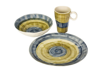 Close-up of a ceramic bowl with a cup and a plate