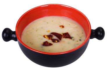 Close-up of a pan of soup with chili flakes