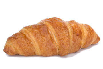 Fresh and tasty croissant over white background