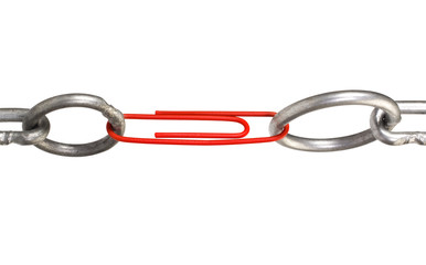 Close-up of a paper clip linking two chains
