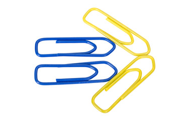 Close-up of paper clips arranged in arrow shape