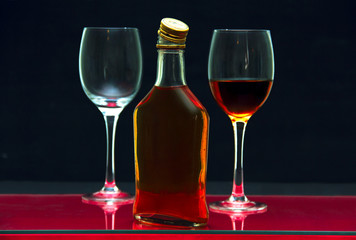 bottle and glasses with alcohol.