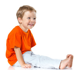 Happy boy sitting on the floor
