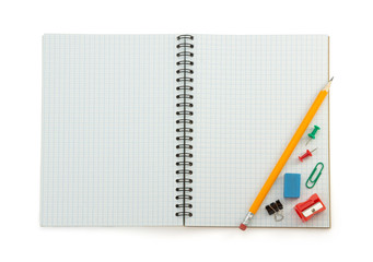 school supplies on checked notebook