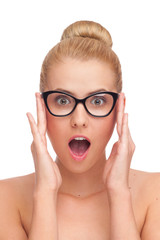 Close-up of a young woman in glasses looking surprised.