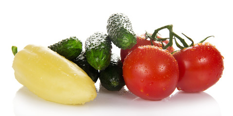 Three red tomatoes and heap of cucumbers