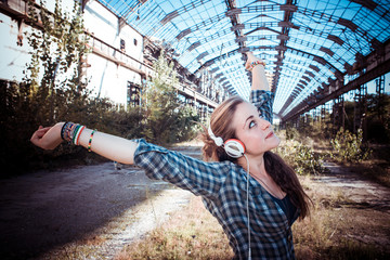 beautiful young blonde hipster woman listening music