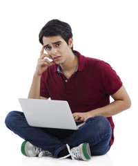 Portrait of a man using a laptop and thinking