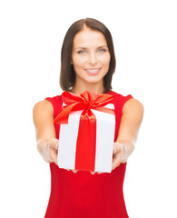 smiling woman in red dress holding gift box