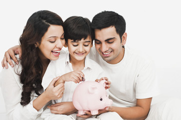 Happy family with a piggy bank