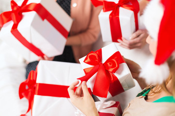 three women holding many gift boxes