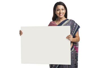 Woman holding at a whiteboard and smiling