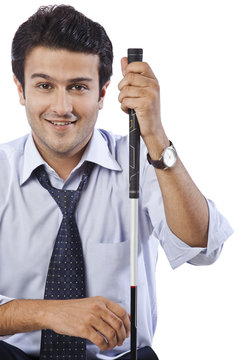 Portrait of a businessman smiling with holding a golf club