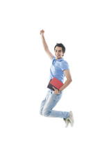 University student holding books and jumping