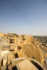 High angle view of Jaisalmer Fort with town in the background, Jaisalmer, Rajasthan, India