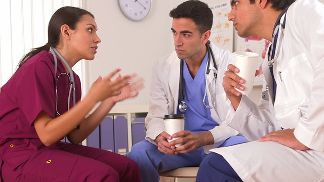 Mexican doctor talking with her colleagues