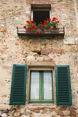 Fototapeta na wymiar Flowers on display on the balcony of a building, Venice, Veneto, Italy