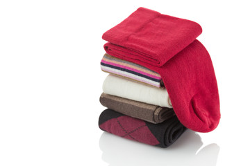 Pile of folded socks over white background