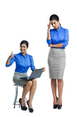 Obraz premium Businesswoman celebrating her success with her clone standing beside her