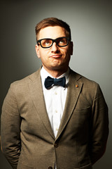 Confident nerd in eyeglasses and bow tie