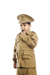 Close-up of a boy dressed as a police uniform blowing a whistle