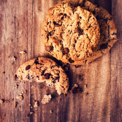 Stacked chocolate chip cookies on wooden rustic background in co