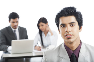 Portrait of a businessman with his colleagues in the background