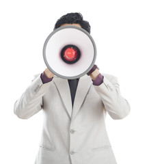 Businessman holding megaphone in front of his face