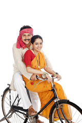 Couple riding a bicycle