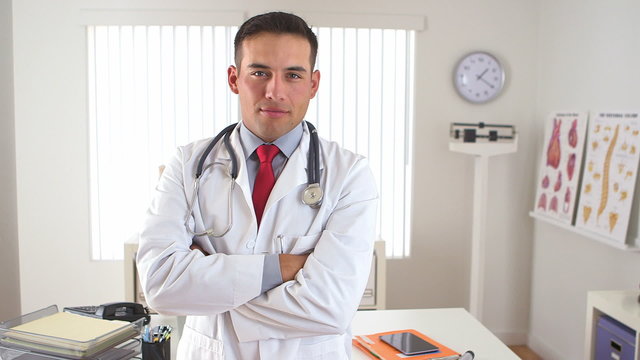 Mexican doctor standing with arms crossed