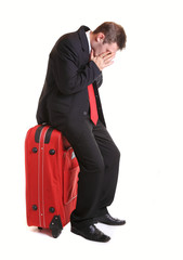 Worried  businessman on luggage