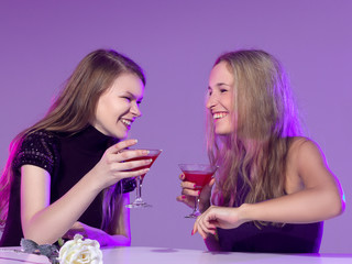 Female friends enjoying cocktails  in a nightclub