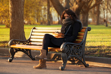 Young sad woman sitting alone