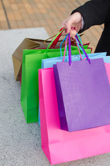 Parts of body of young woman with shopping bags