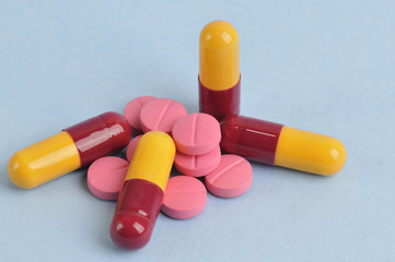 assortment of colorful pills and tablets isolated in blue