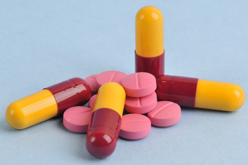 assortment of colorful pills and tablets isolated in blue