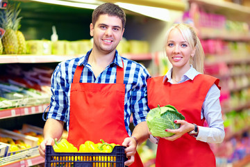 smiling grocery staff working in supermarket