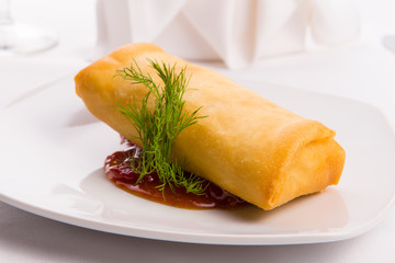 Spring Roll Elegantly Complimented with Dill and Served on Sweet