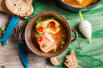 Closeup of fish soup spiced with dill and chilli pepper