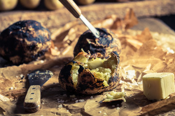 Closeup of fresh jacket potatoes with butter and salt