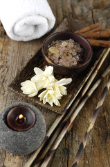 Obraz na płótnie Canvas frangipaniwith salt in bowl and candle on old wood